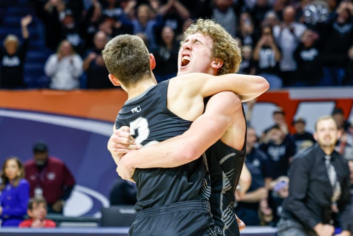 Chance Little hugs Mason Berry as West Central celebrates winning the 2024 Illinois Class 1A boys basketball championship